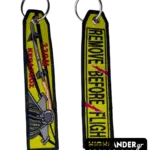 Double-sided embroidered keychain with F-16 jet, "330M KERAVNOS", missile, and "REMOVE BEFORE FLIGHT" with red lightning bolt.