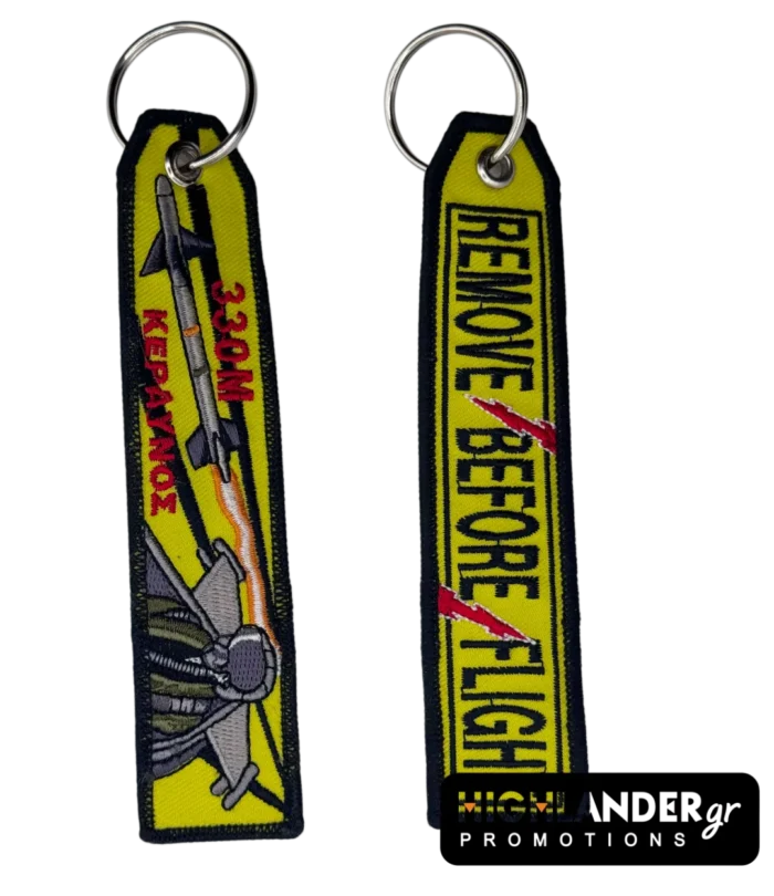 Double-sided embroidered keychain with F-16 jet, "330M KERAVNOS", missile, and "REMOVE BEFORE FLIGHT" with red lightning bolt.