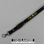 Black lanyard with white F-16 jet silhouette and yellow "F-16 Fighting Falcon" text, metal clasp and detachable buckle.