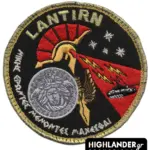 Embroidered patch with Spartan helmet, Medusa shield, red lightning beams, tank, stars, and Greek motto, gold border.