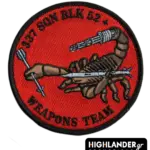 Embroidered patch with brown scorpion holding a grey missile and machine gun, red background, black border, “337 SQN BLK 52+ WEAPONS TEAM” text.