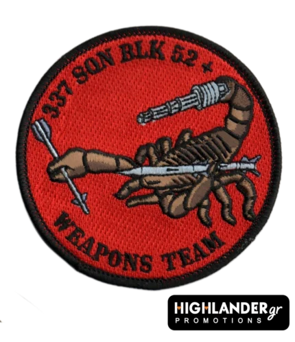 Embroidered patch with brown scorpion holding a grey missile and machine gun, red background, black border, “337 SQN BLK 52+ WEAPONS TEAM” text.