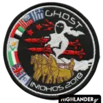 Embroidered patch with white ghost riding golden chariot, firing red missiles, with flags and "INIOHOS 2018" text.
