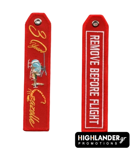 Red embroidered anniversary keychain for SA 342 Gazelle. Side A: "30 Years Gazelle" in gold with scorpion tail and helicopter image. Side B: "REMOVE BEFORE FLIGHT" text.