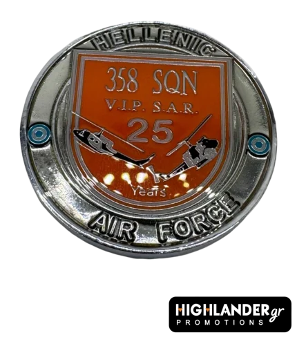 Close-up of the 358 Squadron challenge coin reverse side. A silver coin featuring an orange shield with "358 SQN", "V.I.P. S.A.R.", and "25 Years" text, flanked by two relief helicopters.