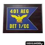 Wooden military plaque for 401 AEG DET 1/CC. Features a blue swallow-tail flag graphic with a yellow eagle and bold text on a dark wood base.