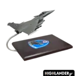 Desktop scale model of a Hellenic Air Force Rafale fighter jet mounted on a wooden base. The base features the HTAF (ATA) eagle emblem.