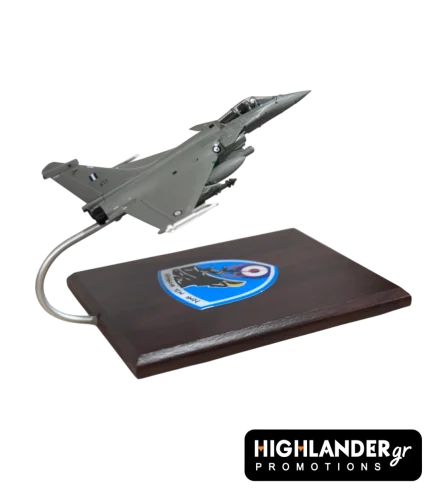 Desktop scale model of a Hellenic Air Force Rafale fighter jet mounted on a wooden base. The base features the HTAF (ATA) eagle emblem.