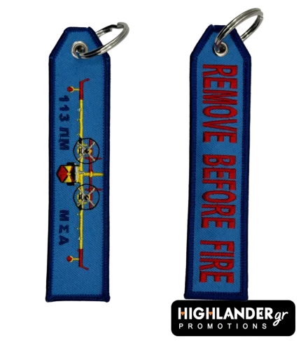 Blue rectangular keychain featuring a yellow Canadair aircraft and 113 PM text on one side, and REMOVE BEFORE FIRE in red text on the other.
