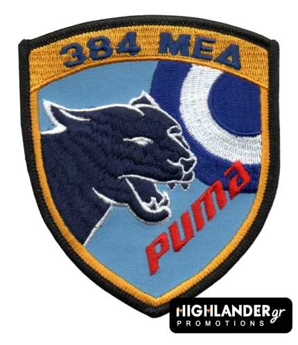 Κεντητό σήμα ασπίδας της 384 ΜΕΔ. Απεικονίζει κεφάλι μαύρου πάνθηρα, εθνόσημο, το κείμενο "384 ΜΕΔ" με μπλε και "puma" με κόκκινα γράμματα σε γαλάζιο φόντο.
