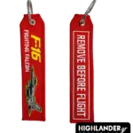 Red embroidered keychain showing F-16 Fighting Falcon jet on one side and Remove Before Flight text in white on the other side.