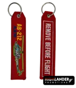 Red embroidered keychain for AB-212 ASW helicopter. Side A shows the helicopter and text. Side B shows "REMOVE BEFORE FLIGHT" in white text.
