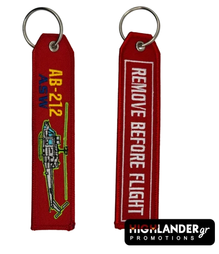 Κόκκινο κεντητό μπρελόκ με το ελικόπτερο AB-212 ASW. Η μία πλευρά δείχνει το ελικόπτερο και η άλλη γράφει "REMOVE BEFORE FLIGHT".