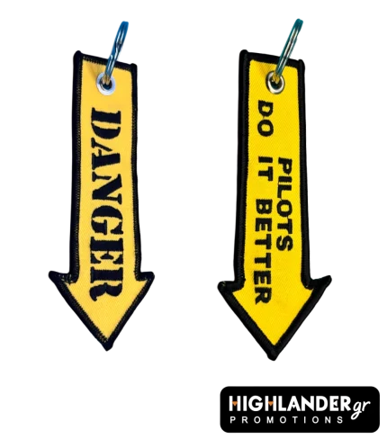 Yellow arrow-shaped embroidered keychain displaying DANGER text on one side and PILOTS DO IT BETTER on the other side.