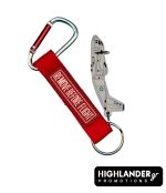 Aviation keychain combo set. Features a grey 3D PVC C-27J Spartan aircraft figure and a red "Remove Before Flight" fabric tag, attached together with a metal carabiner.