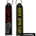 Black rectangular keychain featuring a detailed M53-P2 engine graphic and red text on one side, and yellow REMOVE BEFORE FLIGHT text on the other.
