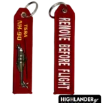 Red embroidered keychain for NH-90 TGRA helicopter from Highlander Promotions. Side A shows the helicopter graphic and yellow text. Side B shows "REMOVE BEFORE FLIGHT".