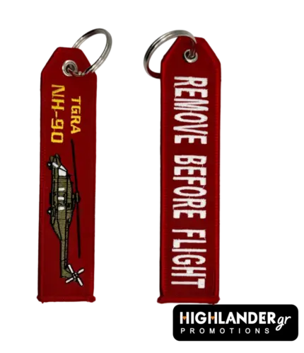 Red embroidered keychain for NH-90 TGRA helicopter from Highlander Promotions. Side A shows the helicopter graphic and yellow text. Side B shows "REMOVE BEFORE FLIGHT".