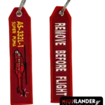 Red embroidered keychain for the AS-332L-1 Super Puma. Side A shows a red helicopter silhouette and yellow model text; Side B shows white "Remove Before Flight" text.