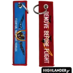 Embroidered keychain from Highlander Promotions. Side A: Fighter Weapons School text with maneuvering jets. Side B: Remove Before Flight with tactical break silhouettes.