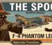 A vintage-style aviation poster for Highlander Promotions featuring "The Spook," the hooded unofficial mascot of the F-4 Phantom. The image shows a camouflage F-4 Phantom II jet with Hellenic Air Force (Greek) blue and white roundel insignia, alongside the "Phantoms Are Phorever" embroidered patch design.
