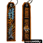 Embroidered keychain. Side A: "Aegean Tiger" text with F-16 aircraft on tiger stripe pattern. Side B: "REMOVE BEFORE FLIGHT" in orange with a claw mark graphic.
