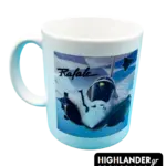 A white ceramic mug featuring a Rafale fighter jet flying in front of a blue and white Greek flag background.