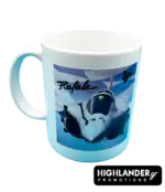 A white ceramic mug featuring a Rafale fighter jet flying in front of a blue and white Greek flag background.