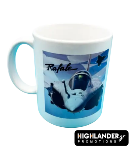 A white ceramic mug featuring a Rafale fighter jet flying in front of a blue and white Greek flag background.
