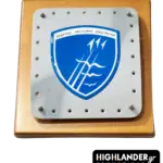 Commemorative wooden plaque with a bolted metallic plate featuring the blue 111 Combat Wing shield and Greek motto.