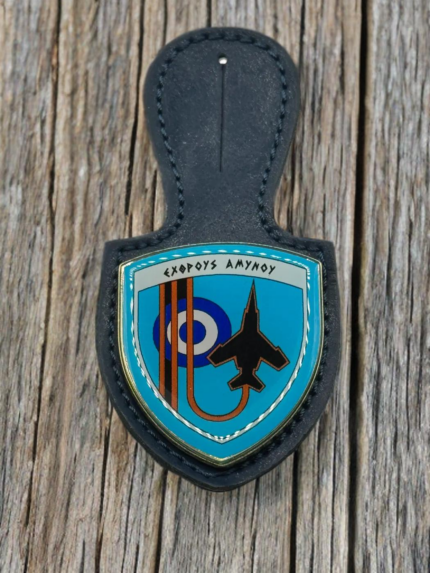 A navy blue leather badge holder featuring the 117 Combat Wing enamel crest with the Greek motto "Exthrous Amynou", a black fighter jet silhouette, and the HAF roundel.