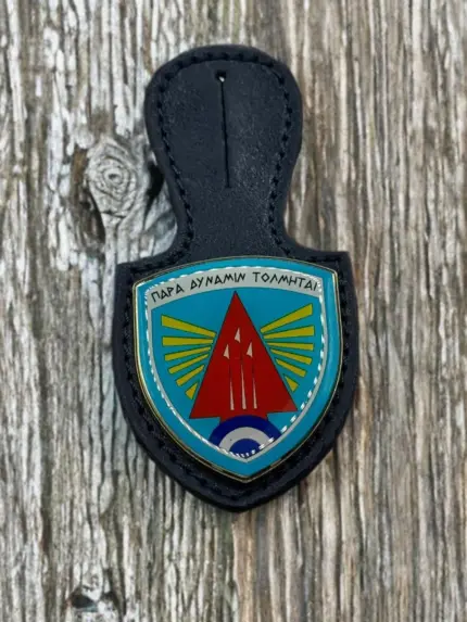A navy blue leather badge holder featuring the 116 Combat Wing enamel crest with a red arrowhead, yellow wings, and the Greek motto "Para Dynamin Tolmitai".