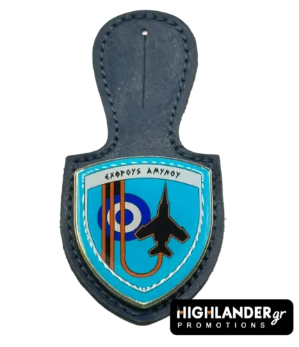 A navy blue leather badge holder featuring the 117 Combat Wing enamel crest with the Greek motto "Exthrous Amynou", a black fighter jet silhouette, and the HAF roundel.