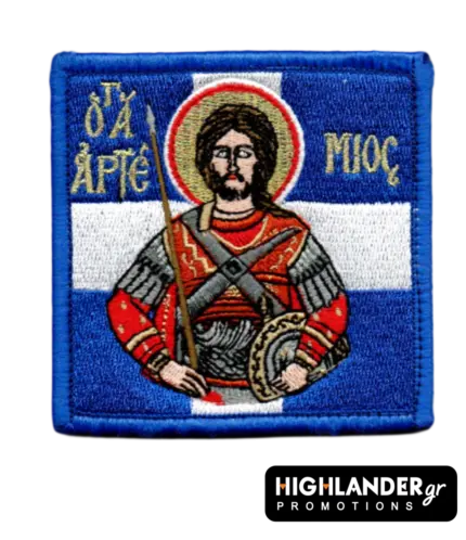 Square embroidered morale patch of Saint Artemios holding a spear and shield, set against a blue and white Greek flag background.
