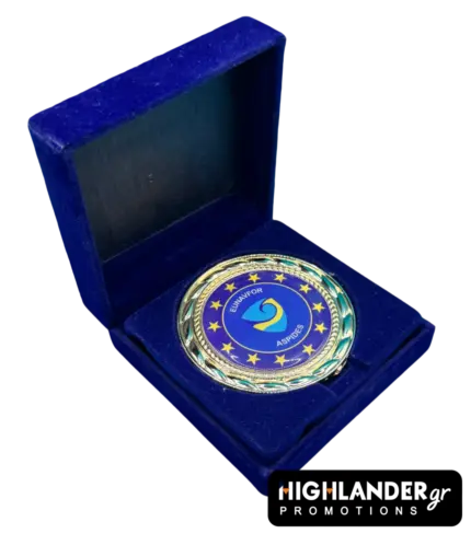 Gold-tone commemorative medallion of EUNAVFOR Operation ASPIDES featuring the blue shield logo and 12 stars, displayed in a blue velvet box.
