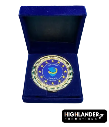 Gold-tone commemorative medallion of EUNAVFOR Operation ASPIDES featuring the blue shield logo and 12 stars, displayed in a blue velvet box.