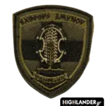 Shield-shaped olive drab tactical patch for the Hellenic National Guard with embroidered shield, spear, and motto "EXTHROUS AMYNOU".