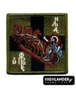 Square embroidered morale patch showing Prophet Elias in a chariot of fire drawn by four horses against a blue and white Greek flag. Camo low visibility edition