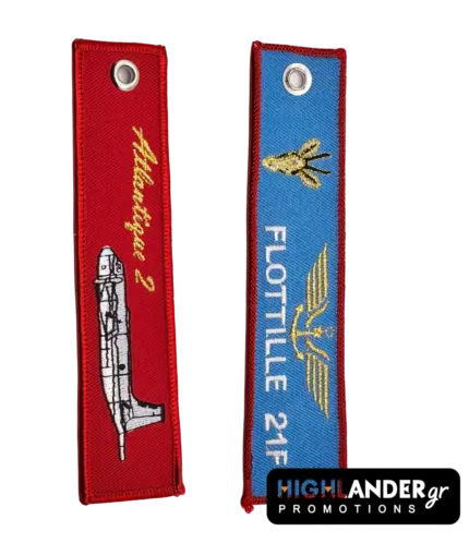 Double-sided fabric keychain featuring the Atlantique 2 aircraft on a red background and Flottille 21F insignia on a blue background.