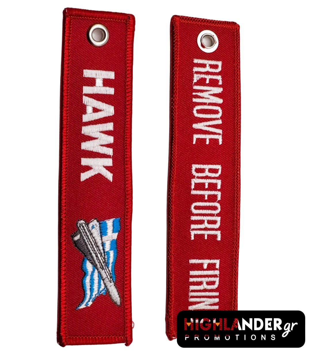 key-hawk Red fabric keychain with embroidered HAWK missile and Greek flag on one side and white "REMOVE BEFORE FIRING" text on the other.