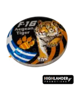 Dual-sided metal challenge coin: one side shows an eagle head with "F-16 Fighting Falcon", the other features a tiger with "F-16 Aegean Tiger" and a paw print.