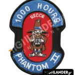 Shaped embroidered flight patch for 1000 hours in Recce Phantoms, featuring a blue Spook mascot with a camera, on a red and blue background.